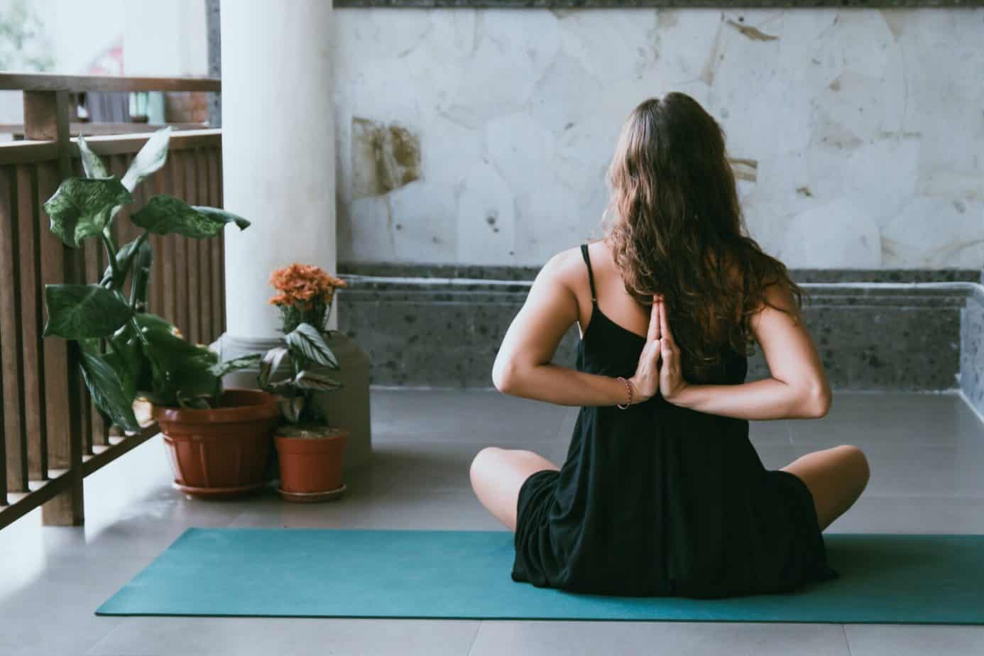 Practice of Yoga: The basic information you need
woman wearing a black top practising yoga on a green mat