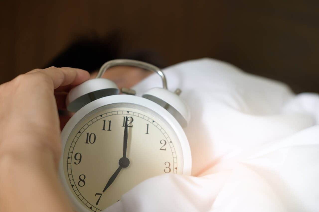 photo of person holding alarm clock