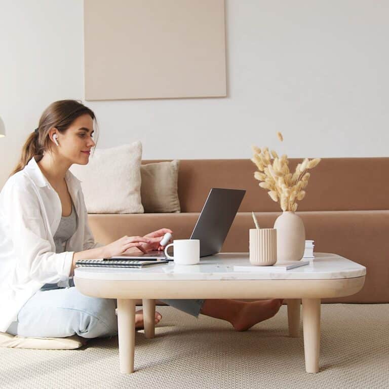 content woman using laptop on floor
