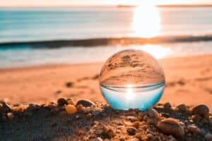 clear glass ball on brown sands