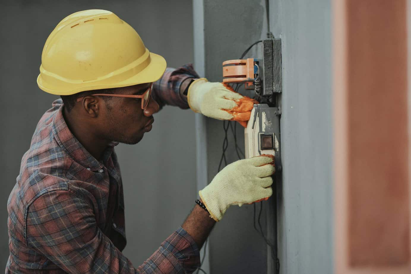 an electrician repairing a fuse box - Safety Tips for Electricity: How to Stay Safe and Ensure That Your Are Covered in and Around Your House