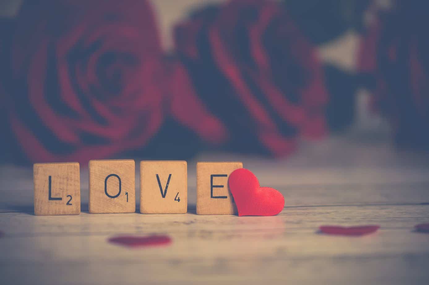 What to give for Valentine's Day - close up photo of wooden scrabble tiles near heart