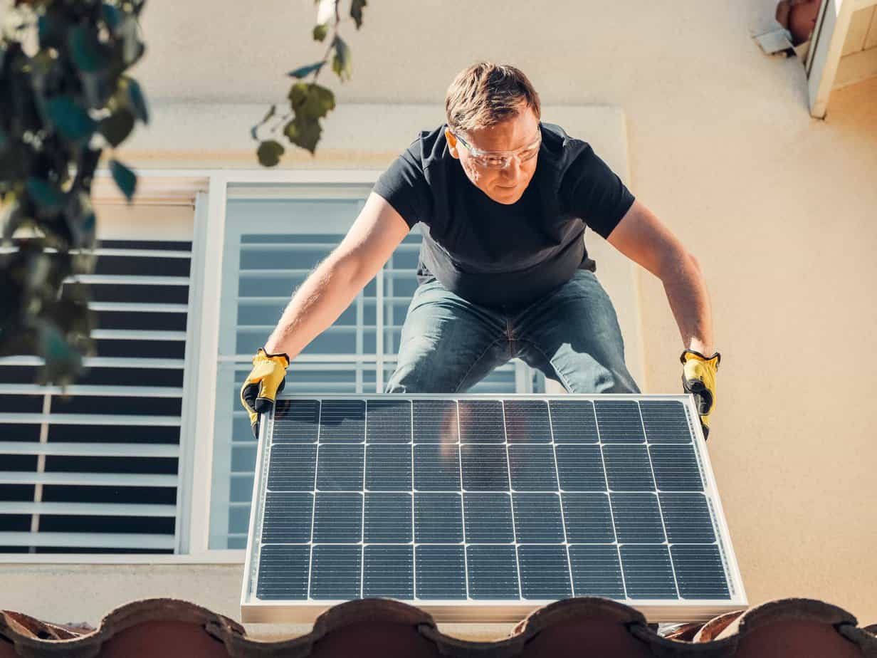 a man installing solar panel - The Advantages and Disadvantages of Solar Energy