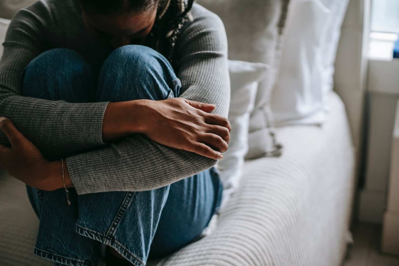 crop pitiful black woman embracing knees on bed - Quotes that could help you through a difficult time