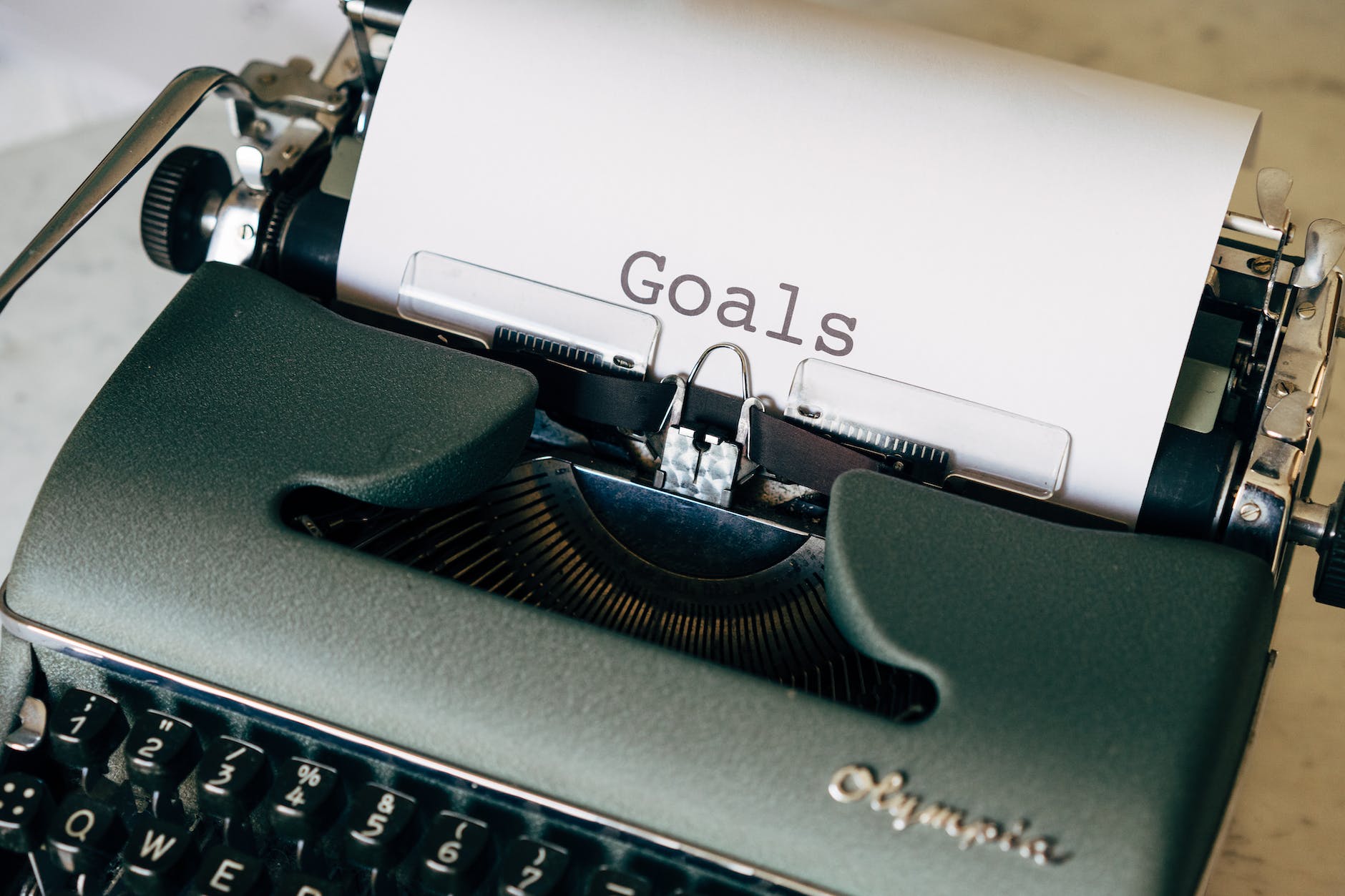 green typewriter on brown wooden table - Things you need to remember when life feels difficult