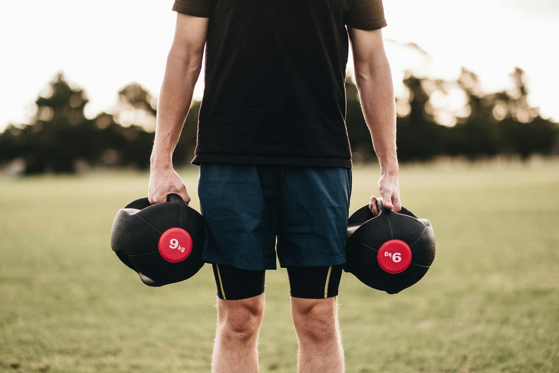 person holding black dumbbells - Ways To Improve Your Lifestyle And It’s Easier Than You Think