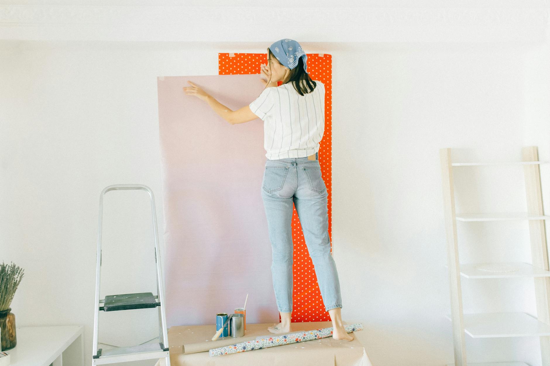 back view of a woman standing on a table near the wall