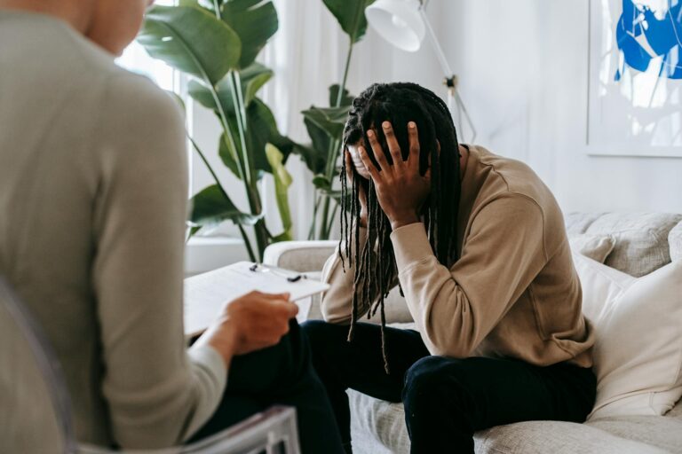 stressed black man with dreadlocks in psychological office