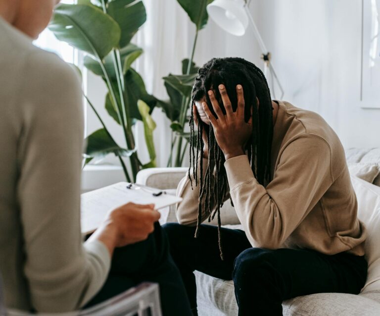 stressed black man with dreadlocks in psychological office